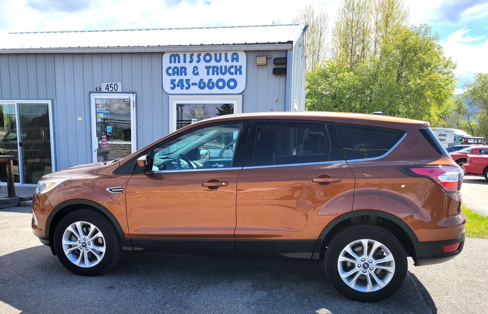 2017 Copper /Black Ford Escape SE (1FMCU9GD1HU) with an 1.5L I4 engine, 6 Speed Auto transmission, located at 450 N Russell, Missoula, MT, 59801, (406) 543-6600, 46.874496, -114.017433 - Nice Low Mile All Wheel Drive. Only 59K Miles. 1.5L I4 Engine. 6 Speed Automatic Transmission. Very Clean. Power drivers Seat. Air. Cruise. Tilt. Power Windows and Locks. Backup Camera. - Photo#0